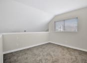 Thumbnail 21 of 32 - an empty bedroom with carpet and a window