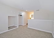 Thumbnail 20 of 32 - the spacious living room and dining room with white walls and carpet