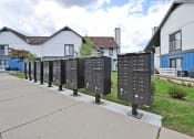 Thumbnail 32 of 32 - a row of mailboxes on a sidewalk in front of houses