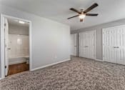 Thumbnail 11 of 24 - A room with a ceiling fan and three doors.