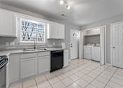 Thumbnail 16 of 24 - A kitchen with white cabinets and appliances.