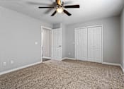 Thumbnail 20 of 24 - A room with a ceiling fan and two doors.