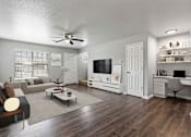 Thumbnail 1 of 24 - A living room with a couch, a coffee table, a television, and a desk.