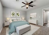 Thumbnail 2 of 24 - A bedroom with a bed, nightstand, and a ceiling fan.