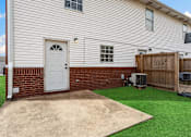 Thumbnail 23 of 24 - A house with a white door and a brown fence.