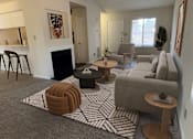 Thumbnail 6 of 32 - A living room with a grey carpet and a fireplace.