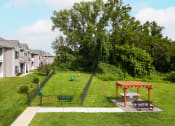 Thumbnail 16 of 25 - a backyard with a dog park and a picnic table