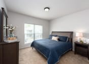 Thumbnail 8 of 25 - a bedroom with a bed and a window