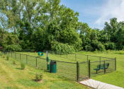 Thumbnail 15 of 25 - a fenced in area with a frisbee in it and a park bench