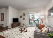 Thumbnail 6 of 25 - a living room with a couch and a tv