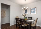 Thumbnail 7 of 25 - a dining room with a table and chairs