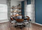 Thumbnail 19 of 25 - a dining room with a table and chairs