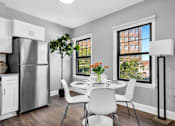 Thumbnail 5 of 44 - A modern kitchen with a dining table set for two.