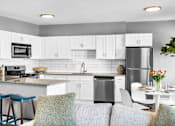 Thumbnail 3 of 44 - A modern kitchen with a dining table set for two.