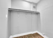 Thumbnail 18 of 44 - A white wall with a grey shelf and a wooden floor.