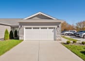 Thumbnail 22 of 24 - a house with a white garage door in front of a driveway