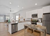 Thumbnail 1 of 24 - a kitchen with white cabinets and stainless steel appliances