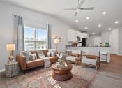 Thumbnail 3 of 24 - a living room with couches and chairs and a ceiling fan