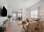 Thumbnail 4 of 24 - a living room with a couch and chairs and a tv