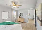 Thumbnail 12 of 24 - a bedroom with a bed and a ceiling fan