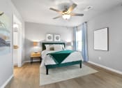 Thumbnail 10 of 24 - a bedroom with a bed and a ceiling fan