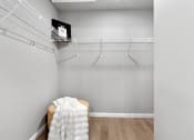 Thumbnail 19 of 24 - an empty closet with a chair and a wire rack on the wall