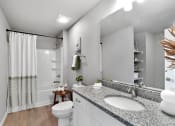 Thumbnail 15 of 24 - a bathroom with a sink and a toilet and a shower