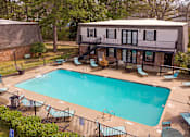 Thumbnail 14 of 15 - A small pool surrounded by a black fence and chairs.