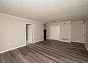Thumbnail 5 of 15 - A room with wood flooring and white walls.