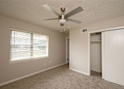 Thumbnail 9 of 15 - A room with a ceiling fan and a window with blinds.