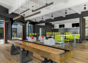 Thumbnail 2 of 82 - a large wooden table in the middle of a room with green chairs and white couches