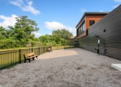 Thumbnail 46 of 82 - a large patio with two benches and a black fence