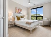 Thumbnail 9 of 82 - a bedroom with a bed and a chair