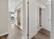 Thumbnail 21 of 82 - a bedroom with white doors and hardwood floors