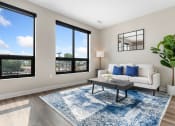 Thumbnail 20 of 82 - a living room with a white couch and a blue rug