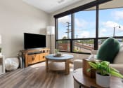 Thumbnail 15 of 82 - a living room with a large window and a flat screen tv