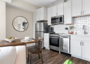 Thumbnail 13 of 82 - a kitchen and dining area in a 555 waverly unit