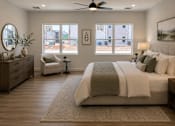 Thumbnail 2 of 4 - A bedroom with a large bed, a chair, and a ceiling fan.