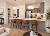 Thumbnail 1 of 4 - A modern kitchen with a bar area and seating.