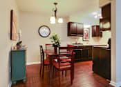 Thumbnail 4 of 24 - A kitchen with a table and chairs.