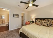 Thumbnail 8 of 24 - A bedroom with a bed, pillows, and a ceiling fan.