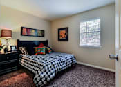 Thumbnail 9 of 24 - A bedroom with a bed, dresser, and window.
