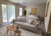 Thumbnail 2 of 19 - a living room with a couch and a coffee table