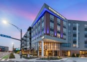 Thumbnail 4 of 82 - a large hotel building on a city street at dusk