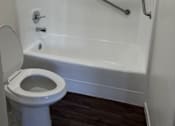 Thumbnail 8 of 19 - a white bathroom with a toilet and a shower