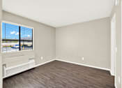 Thumbnail 17 of 23 - A room with a window overlooking a highway.