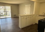 Thumbnail 13 of 19 - an empty kitchen with white cabinets and a sink