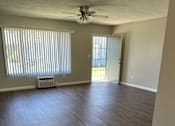 Thumbnail 17 of 35 - an empty living room with a ceiling fan