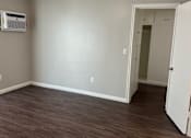 Thumbnail 22 of 35 - an empty living room with wood floors and a ceiling fan