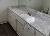 Thumbnail 23 of 35 - a bathroom with a sink and a mirror